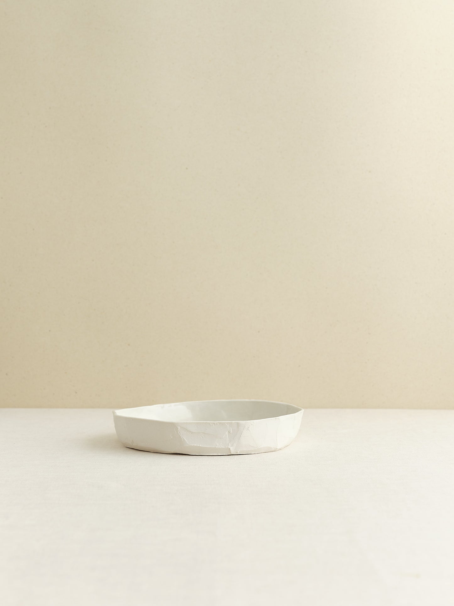 high-walled medium sized porcelain plate is handmade in Zurich