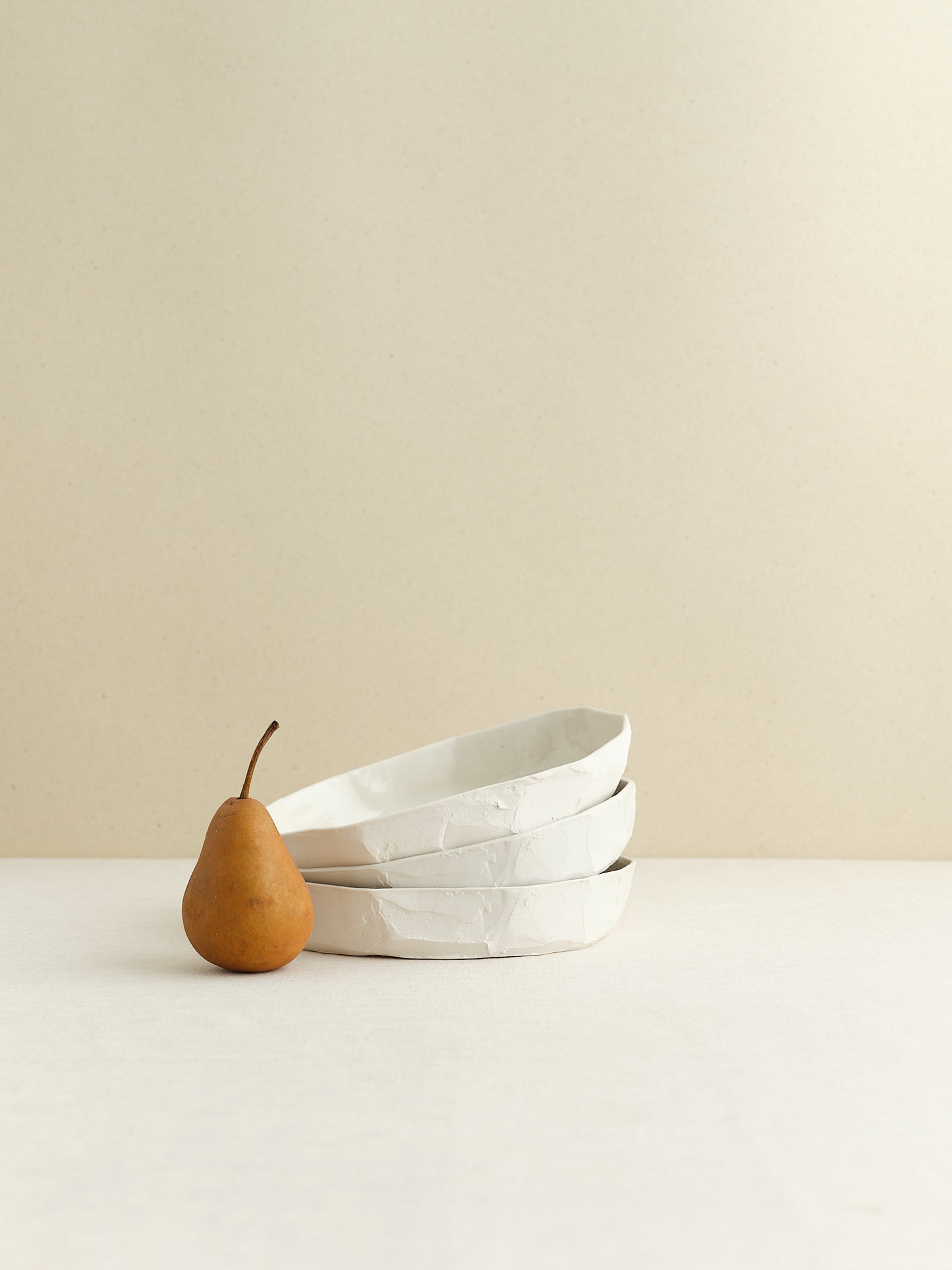 high-walled medium sized porcelain plate is handmade in Zurich